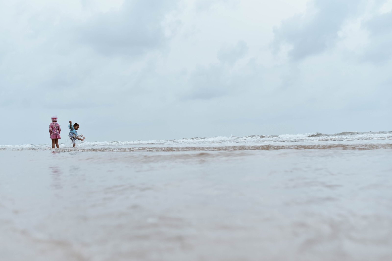 two children on beach shore